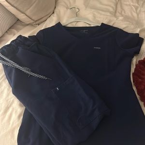 XS brand new Jaanuu navy scrubs. Bottoms are joggers. Open to offers